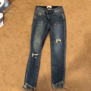 Free People light denim jeans with fringe bottom